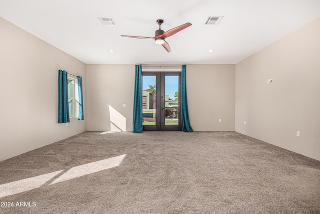 carpeted empty room featuring ceiling fan and french doors