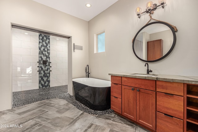 bathroom with vanity and independent shower and bath