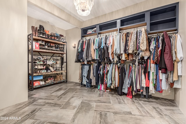 spacious closet with a chandelier