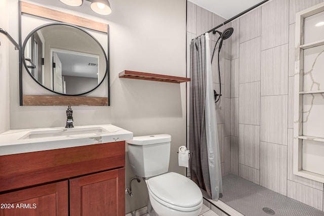 bathroom featuring tile patterned floors, vanity, curtained shower, and toilet