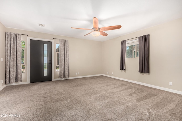 carpeted empty room featuring ceiling fan