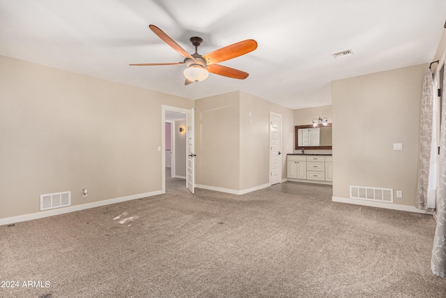 unfurnished living room featuring ceiling fan and carpet floors