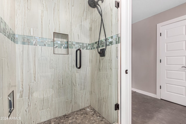 bathroom featuring a shower with shower door