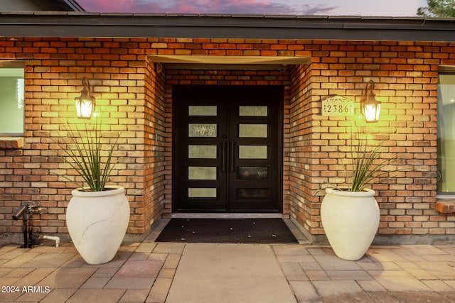 view of exterior entry at dusk