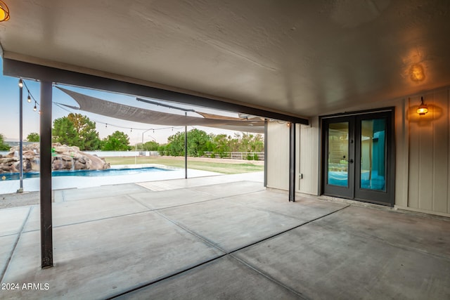 view of patio featuring pool water feature and french doors