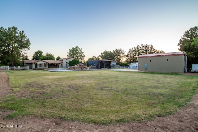 view of yard at dusk