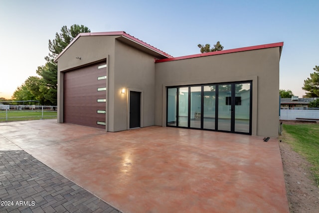 modern home featuring a garage and an outdoor structure