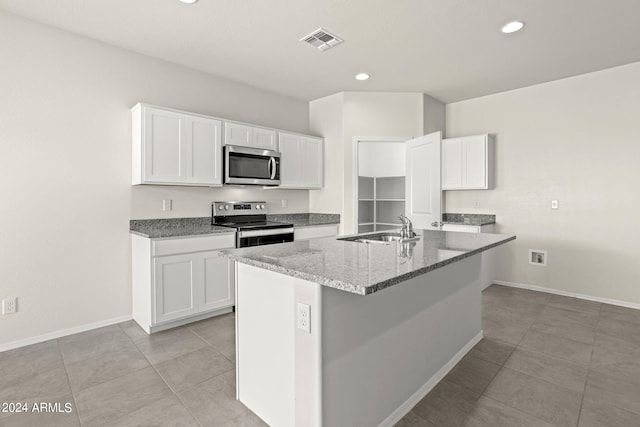 kitchen featuring stone counters, sink, an island with sink, white cabinets, and appliances with stainless steel finishes