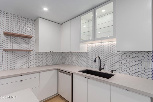 kitchen featuring a sink, stainless steel dishwasher, white cabinets, open shelves, and recessed lighting