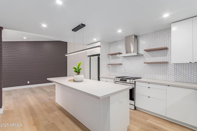 kitchen featuring gas stove, wall chimney exhaust hood, open shelves, freestanding refrigerator, and recessed lighting