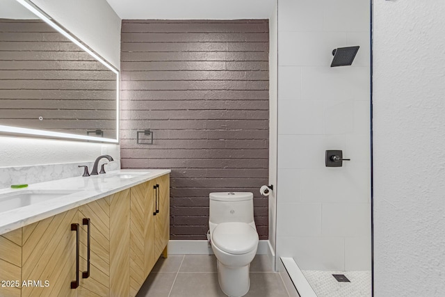 bathroom with tile patterned flooring, toilet, a tile shower, and double vanity