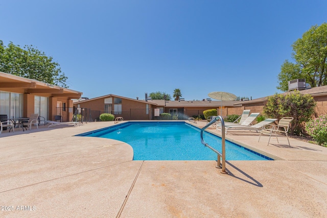 community pool featuring a patio area and fence