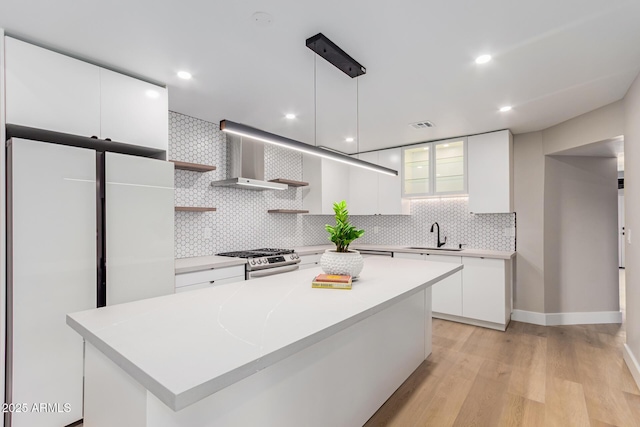 kitchen featuring gas stove, open shelves, decorative backsplash, white cabinets, and modern cabinets