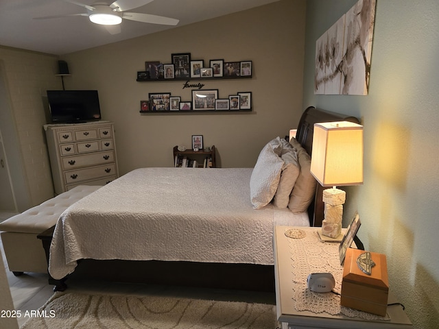 bedroom featuring lofted ceiling and a ceiling fan