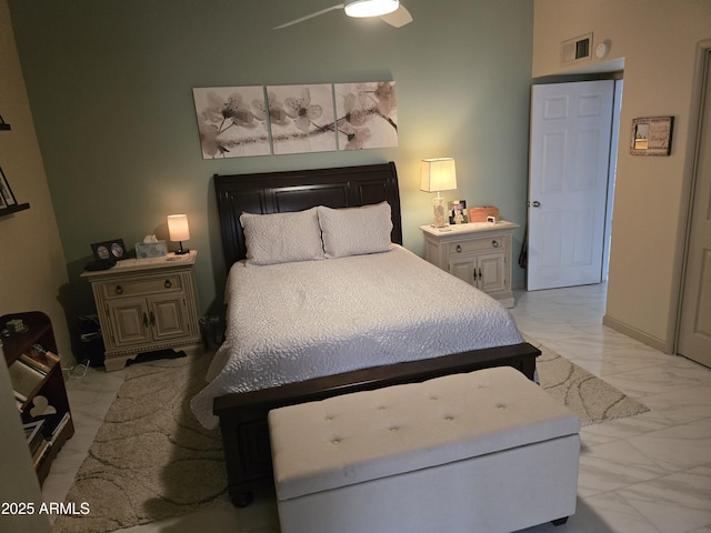 bedroom featuring marble finish floor, visible vents, and baseboards