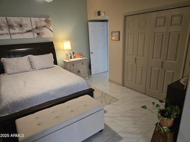 bedroom with marble finish floor, baseboards, visible vents, and a closet