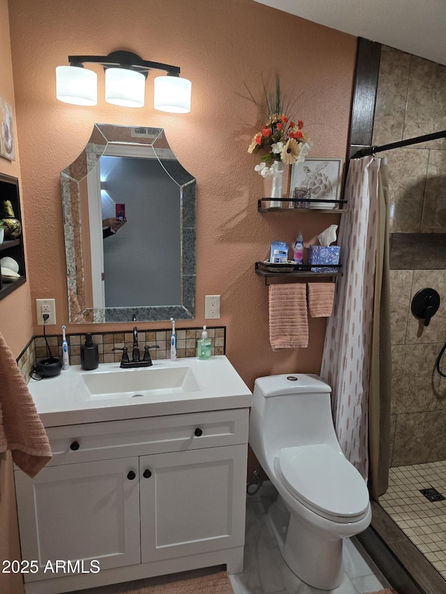 bathroom featuring toilet, a stall shower, a textured wall, and vanity