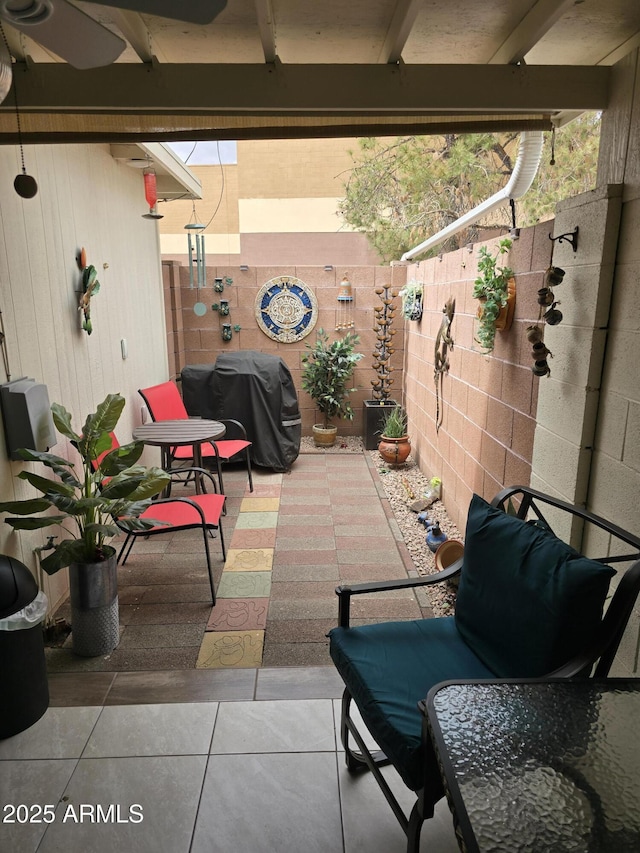 view of patio / terrace with a grill and fence