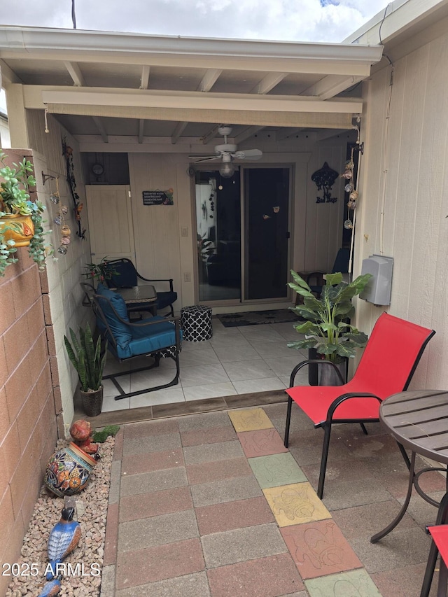 doorway to property featuring a ceiling fan and a patio area