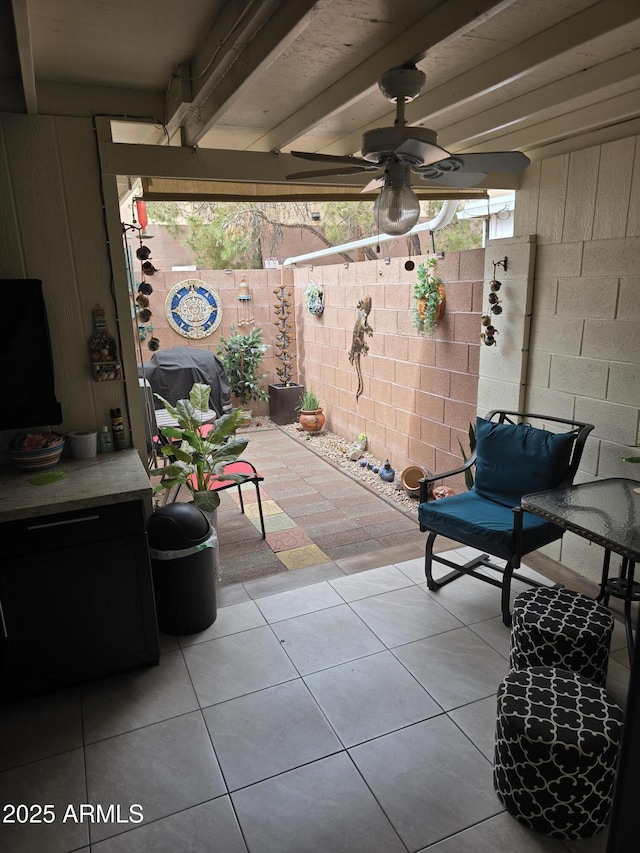 view of patio / terrace with fence and a ceiling fan