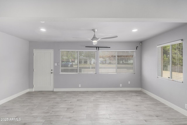 unfurnished room featuring a ceiling fan, recessed lighting, light wood-style floors, and baseboards