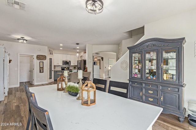 dining room with dark hardwood / wood-style flooring