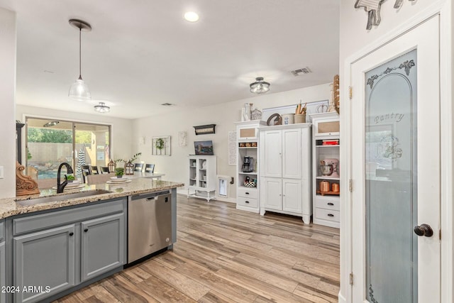 kitchen with dishwasher, sink, gray cabinets, light wood-type flooring, and decorative light fixtures