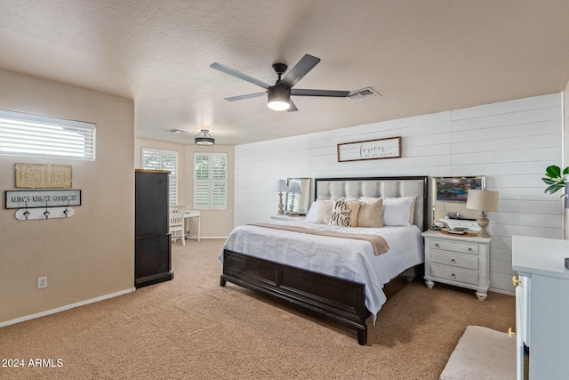 carpeted bedroom featuring a textured ceiling and ceiling fan