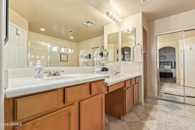 bathroom featuring vanity, a textured ceiling, and walk in shower