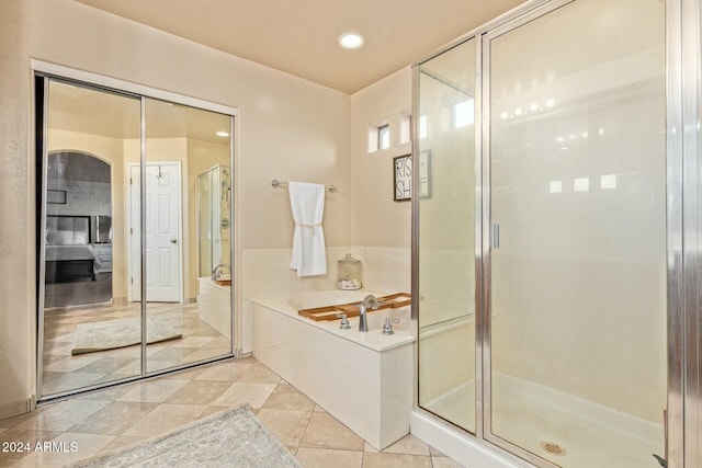 bathroom with tile patterned flooring and plus walk in shower