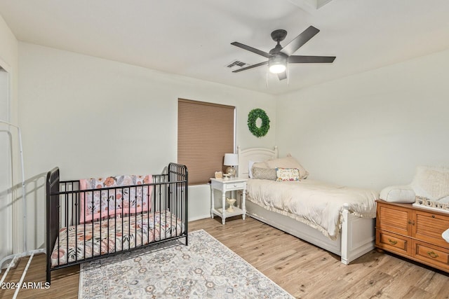 bedroom with light hardwood / wood-style floors and ceiling fan