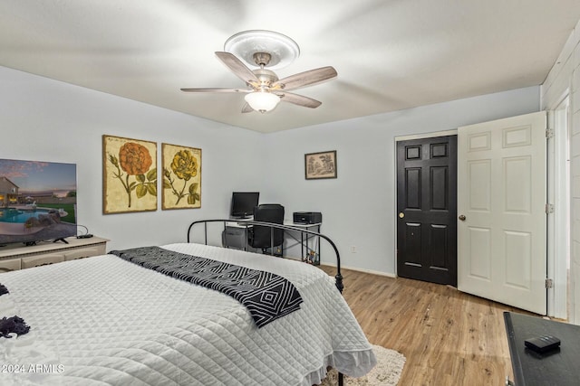 bedroom with ceiling fan and light hardwood / wood-style floors