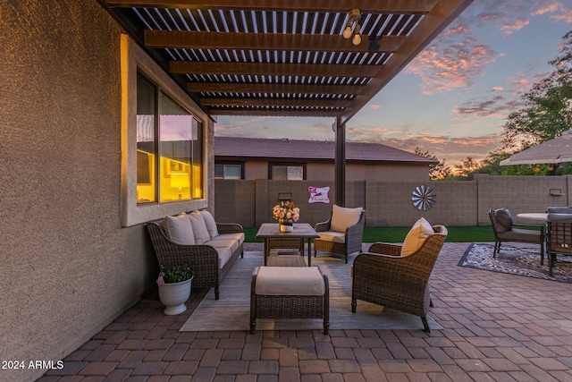 patio terrace at dusk featuring a pergola and outdoor lounge area