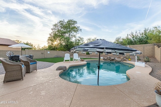 view of pool with a yard and a patio area