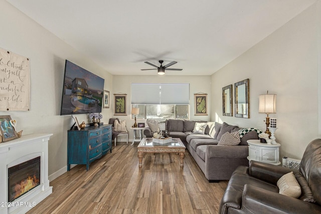 living room featuring ceiling fan and hardwood / wood-style flooring