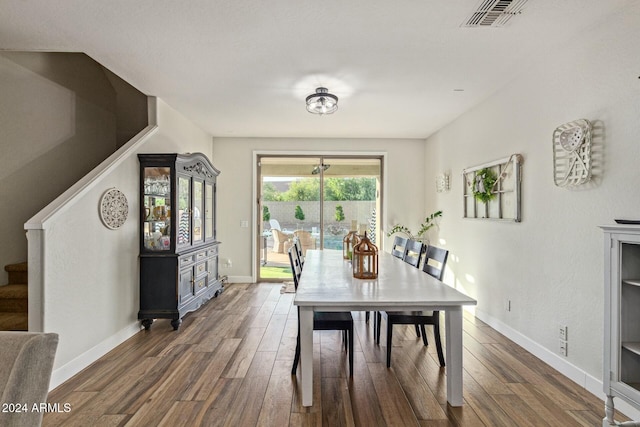 dining area featuring dark wood-type flooring