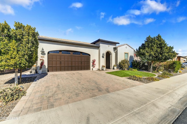 mediterranean / spanish-style home with a garage