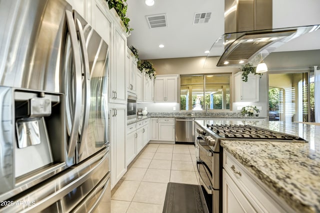 210 E Bergamot Ln, Queen Creek, AZ 85140 - kitchen with stainless steel appliances, light tile patterned floors, white cabinetry, light stone counters, and recessed lighting
