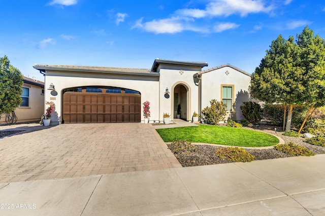 210 E Bergamot Ln, Queen Creek, AZ 85140 - mediterranean / spanish-style home with an attached garage, decorative driveway, a front yard, and stucco siding