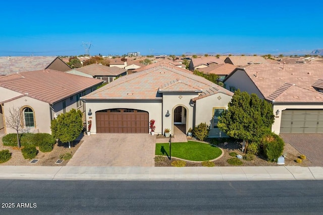 210 E Bergamot Ln, Queen Creek, AZ 85140 - mediterranean / spanish home featuring an attached garage, stucco siding, driveway, and a residential view