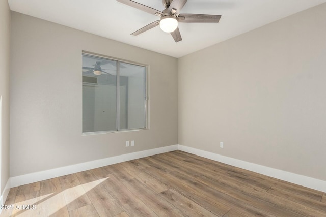 spare room featuring ceiling fan and light hardwood / wood-style flooring