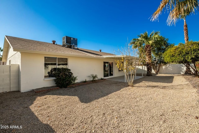 rear view of house with a patio and central AC unit