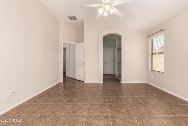385 E Ironwood Dr, Chandler, AZ 85225 - unfurnished room featuring arched walkways, ceiling fan, tile patterned flooring, baseboards, and lofted ceiling