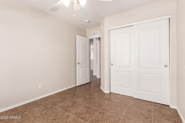 385 E Ironwood Dr, Chandler, AZ 85225 - unfurnished bedroom with baseboards, tile patterned flooring, a closet, and ceiling fan
