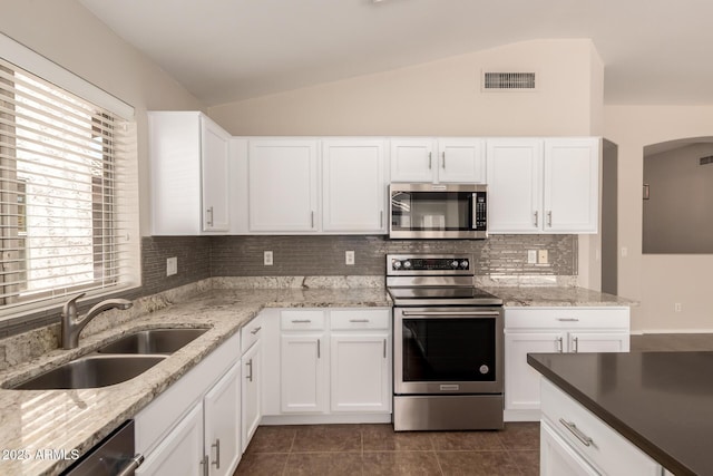 385 E Ironwood Dr, Chandler, AZ 85225 - kitchen with appliances with stainless steel finishes, lofted ceiling, a sink, backsplash, and dark tile patterned floors