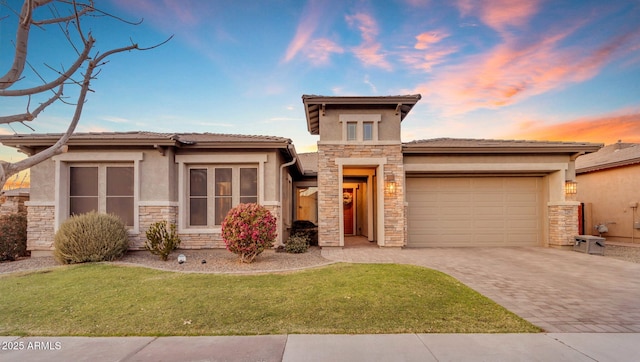 prairie-style home with a yard and a garage