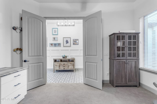 bathroom with plenty of natural light and a notable chandelier