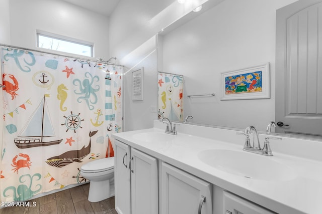 bathroom featuring wood-type flooring, toilet, a shower with shower curtain, and vanity