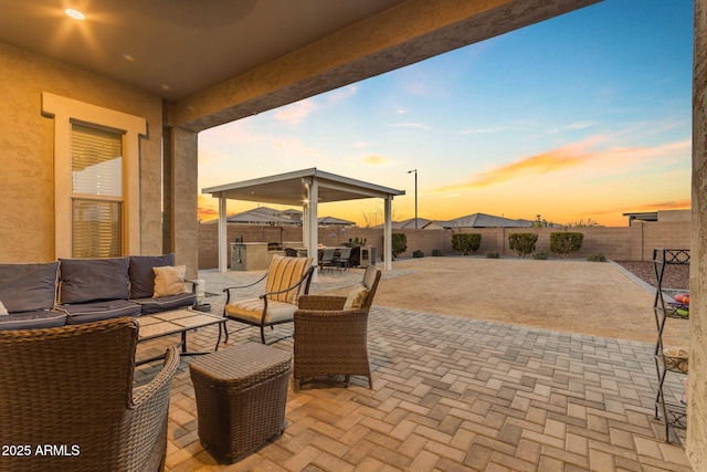 patio terrace at dusk featuring outdoor lounge area