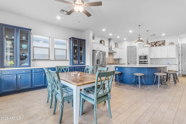 dining space featuring light wood-type flooring and ceiling fan